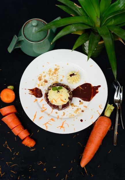 Carrot chocolate cake on plate and black background