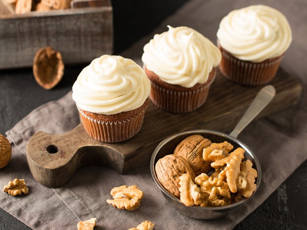 Carrot cupcakes or muffins with nuts on black