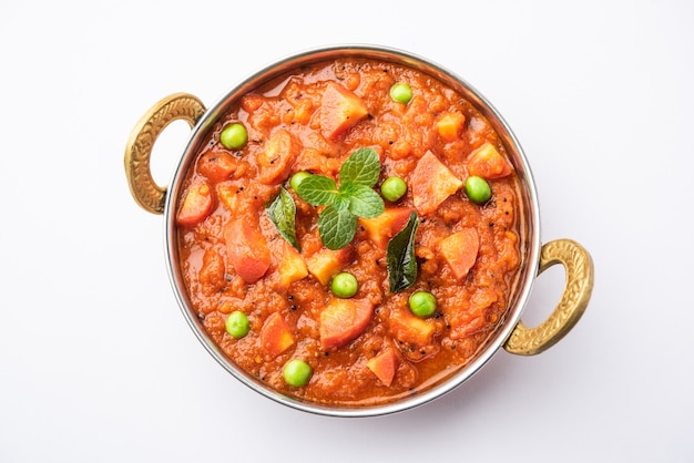 Carrot Curry or Garar Gravy sabzi made using tomato puree and spices, served in a bowl