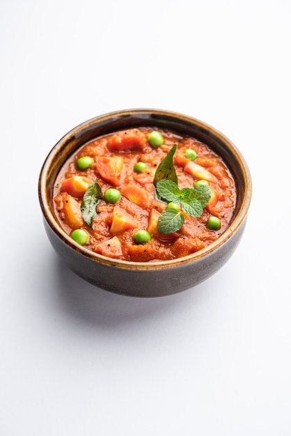 Carrot Curry or Garar Gravy sabzi made using tomato puree and spices, served in a bowl