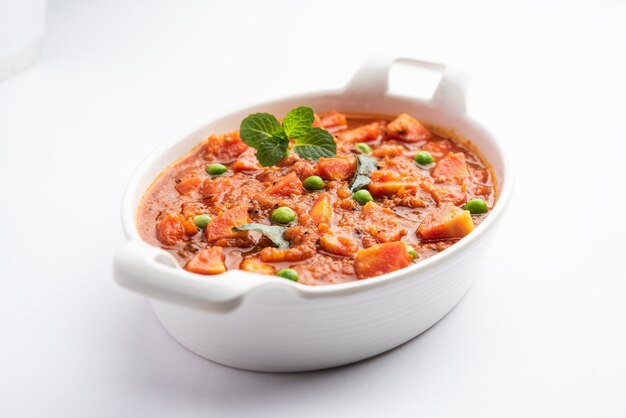 Carrot Curry or Garar Gravy sabzi made using tomato puree and spices, served in a bowl