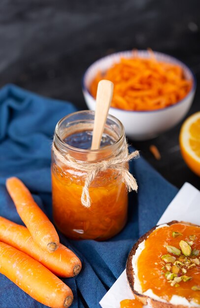 Carrot Jam with orange juice on a black background