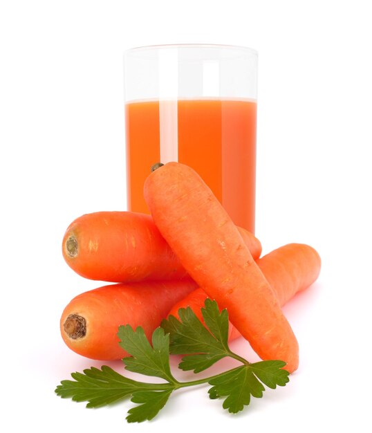 Carrot juice glass and carrot tubers