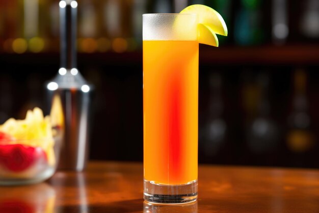 Carrot juice mixed with other fruit juices in a tall glass
