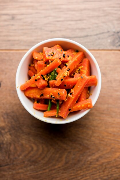 Carrot Pickle or Gajar ka Achar or Loncha in hindi. Served in a bowl over moody background. Selective focus