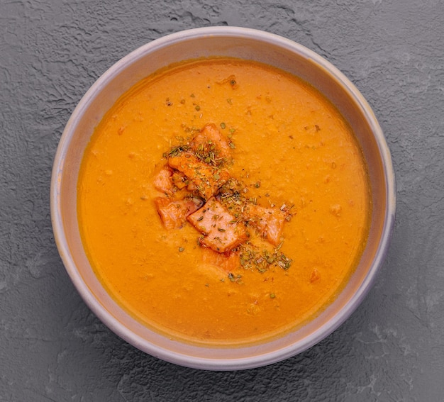 Carrot pumpkin cream soup with salmon