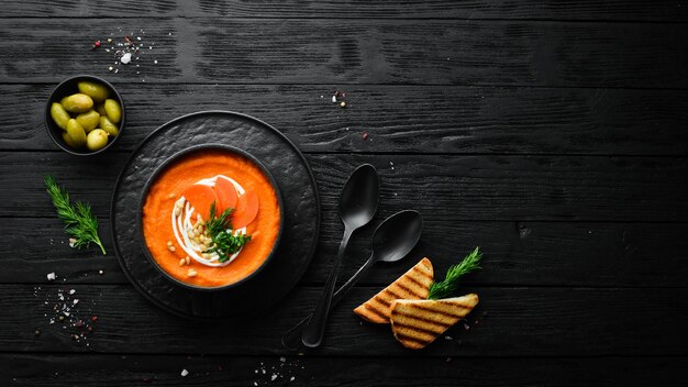 Carrot puree soup with cream and pine nuts Vegan food Top view Free space for your text