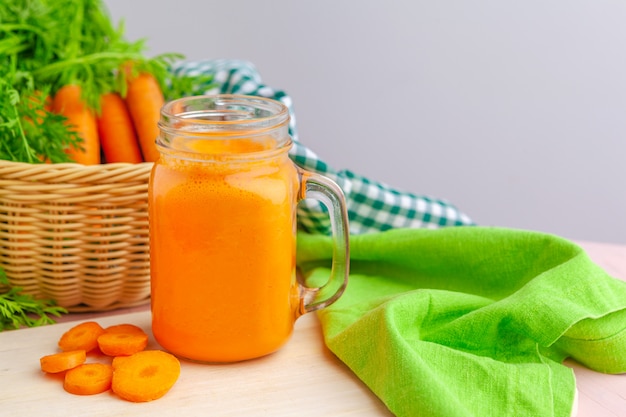 Carrot smoothie with parsley on a table