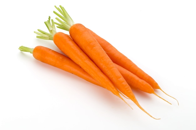Carrot vegetable with leaves on the white surface