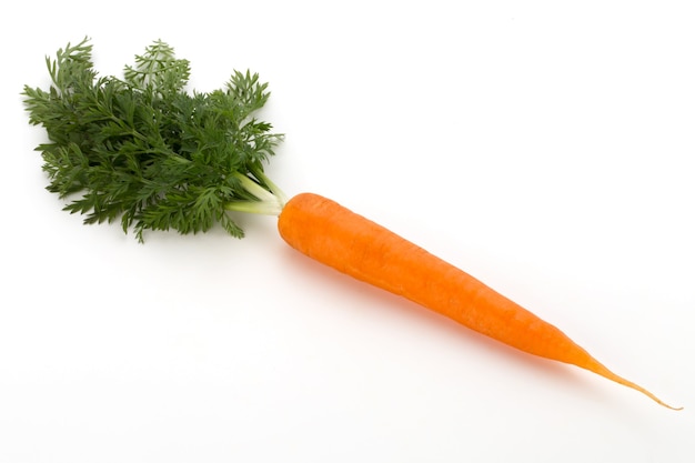 Carrot vegetable with leaves on the wood