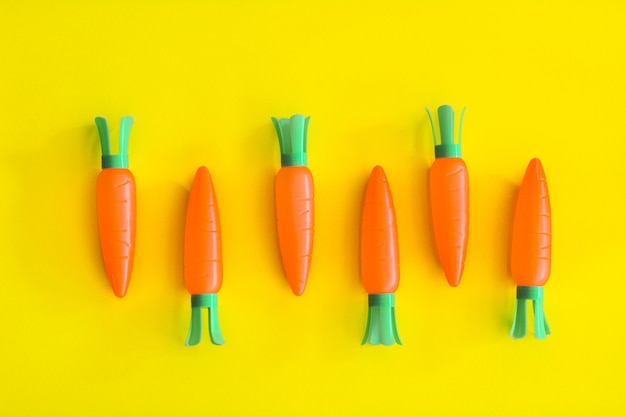 Photo carrots abstract minimal yellow background, food concept