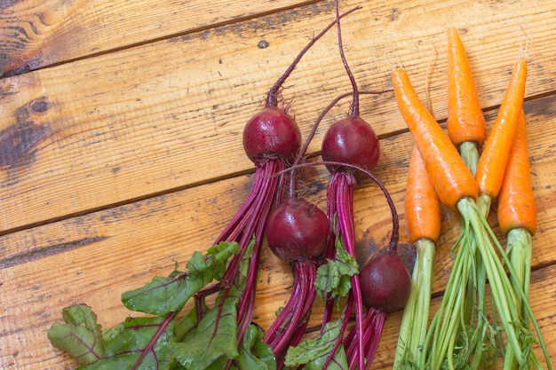 Carrots and Beets with stems and leaves.