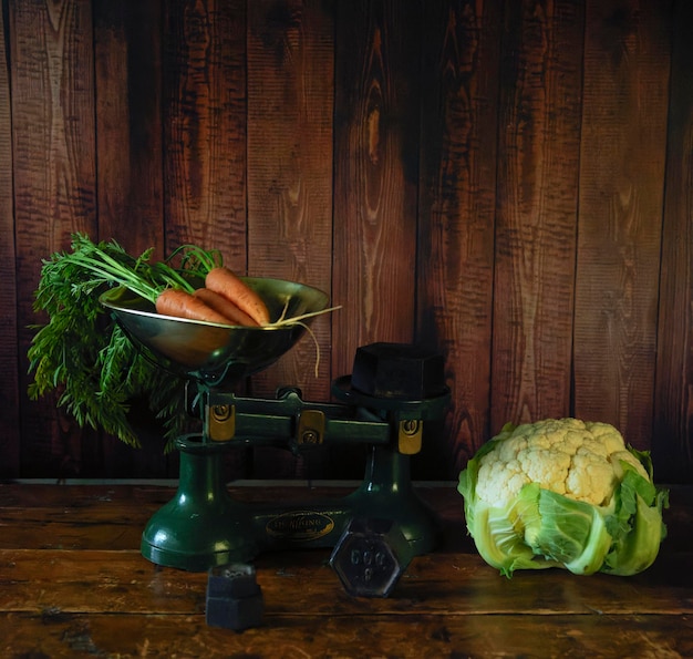 Carrots being weighed with a cauliflower