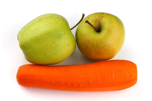 Carrots and green apples on a white surface