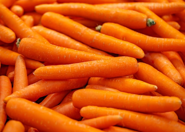 Carrots peeled in bulk on supermarket selective focus
