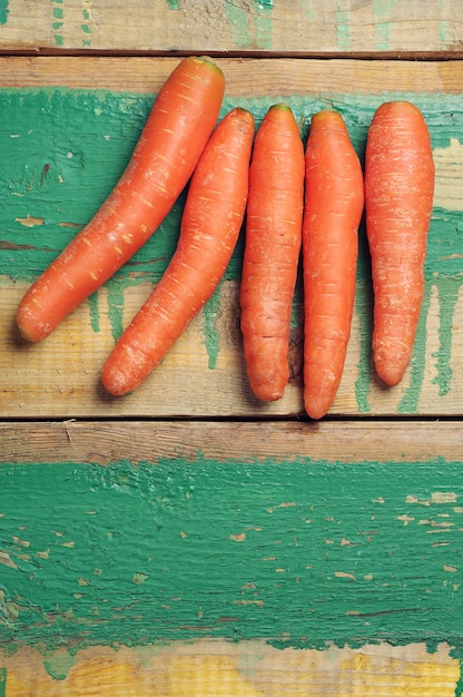 Carrots on vintage wooden background