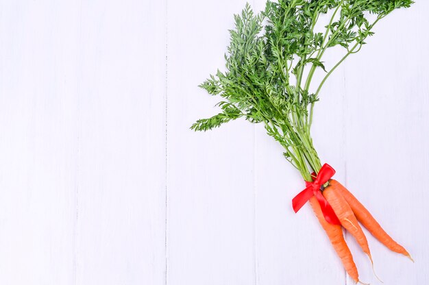 Carrots on a white wooden table