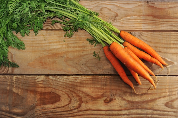 Carrots  with raw vegetables with tops