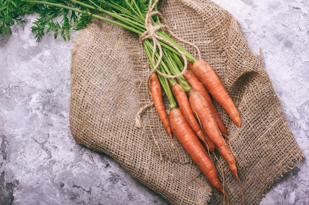 Carrots with tops on burlap