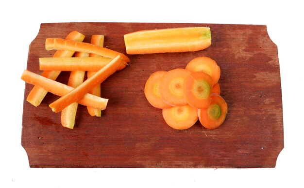 Carrots on a wooden cutting board isolated on a white background