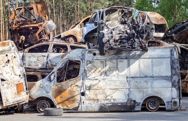 Photo cars after the fire iron parts of a burnt car burntout cars abandoned on the side of a quiet