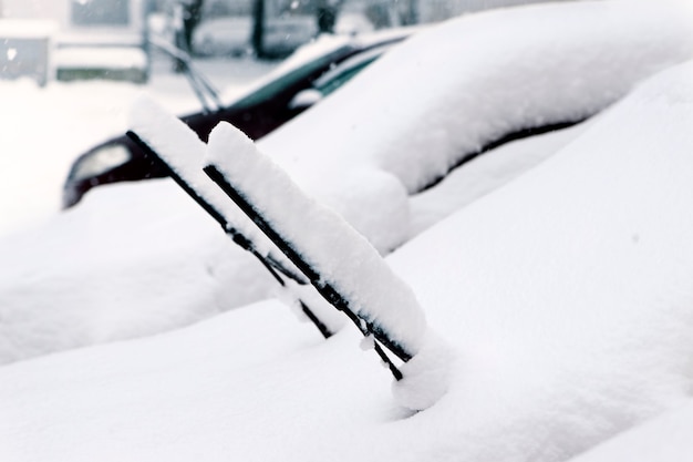 Cars after a snowfall. Windshield wiper raised up.