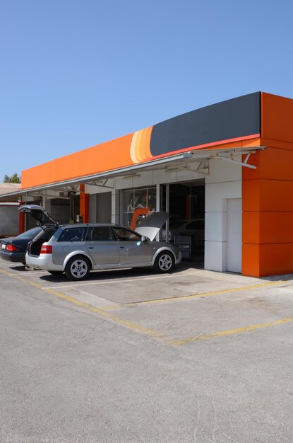 Cars are parked outside a car service building in greece