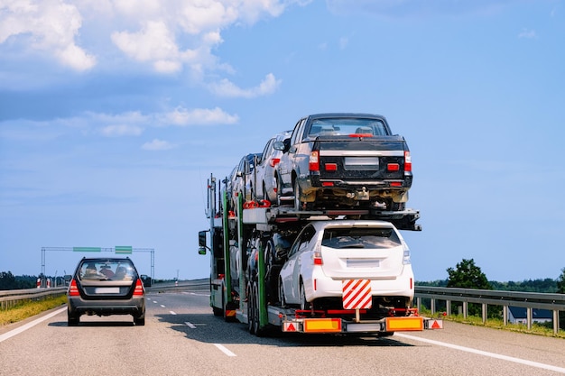 Cars carrier at the road in Poland. Truck transporter