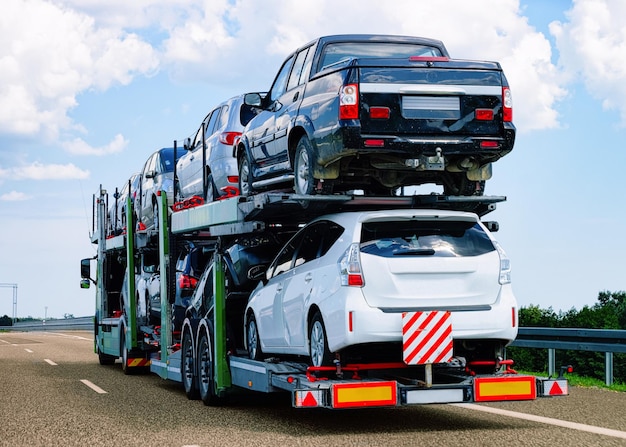 Cars carrier at the road of Poland. Truck transporter