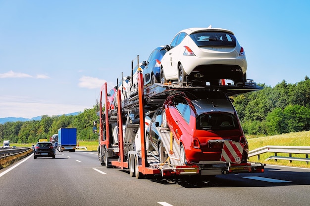 Cars carrier truck at the highway asphalt road of Poland. Truck transporter