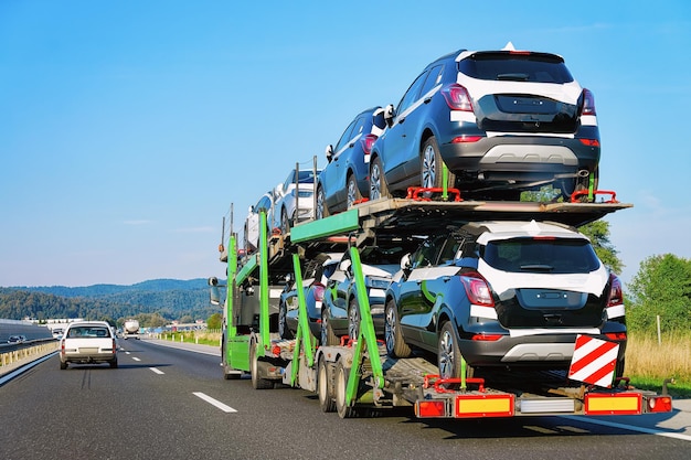 Cars carrier truck in the highway asphalt road, Poland. Truck transporter