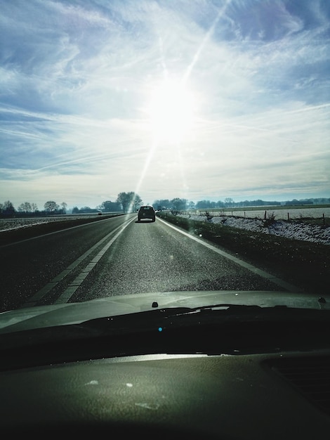 Cars on highway seen through car windshield