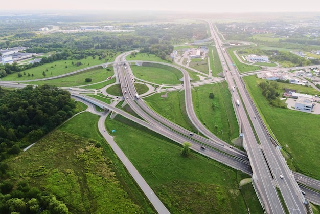 Cars moving on transport road junction in city aerial view