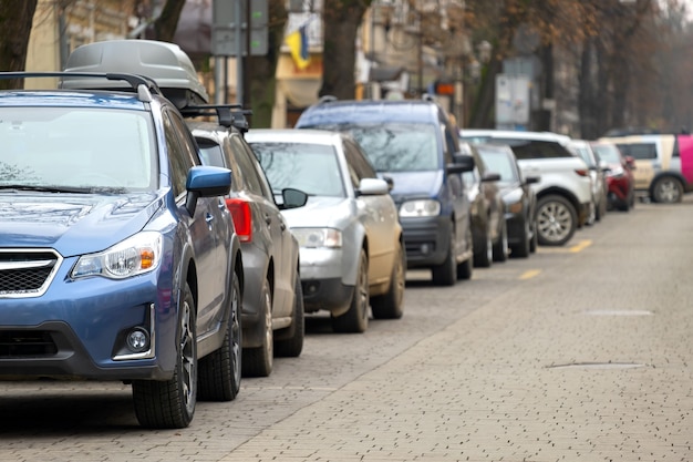 Cars parked in a row on a city street side.