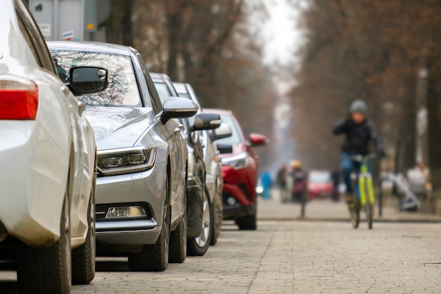 Cars parked in a row on a city street side.