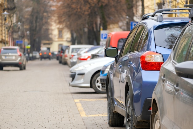 Cars parked in a row on a city street side.