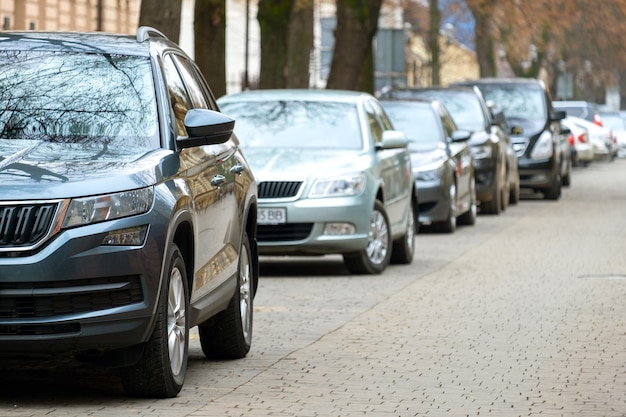 Cars parked in a row on a city street side.