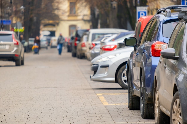 Cars parked in a row on a city street side.