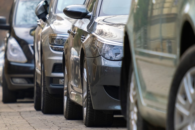 Cars parked in a row on a city street side.