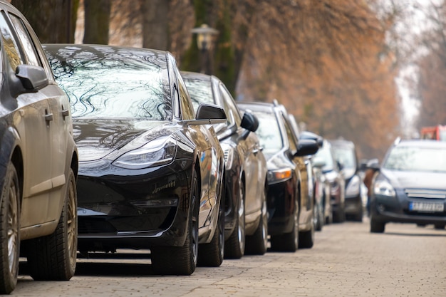 Cars parked in a row on a city street side.