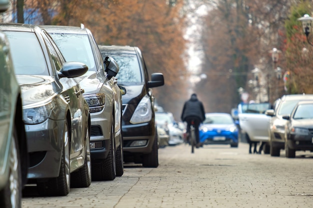 Cars parked in a row on a city street side.