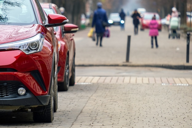 Cars parked in a row on a city street side.