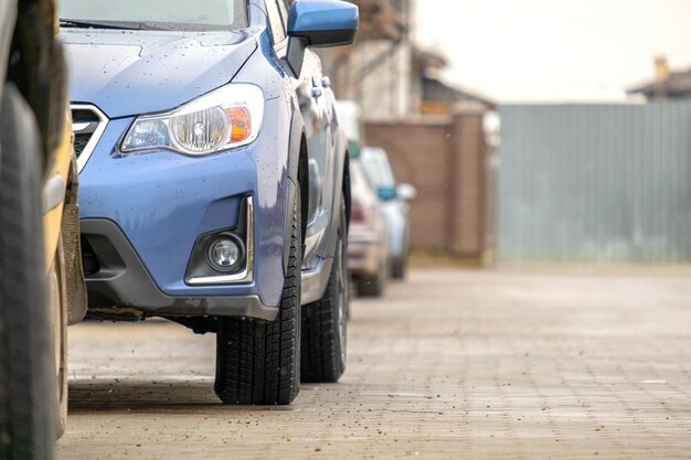 Cars parked in a row on a city street side.