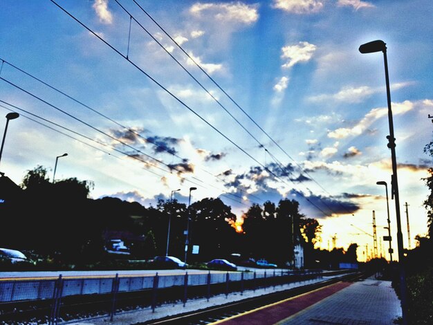 Cars on road against sky during sunset