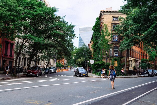 Cars on road by buildings in city against sky