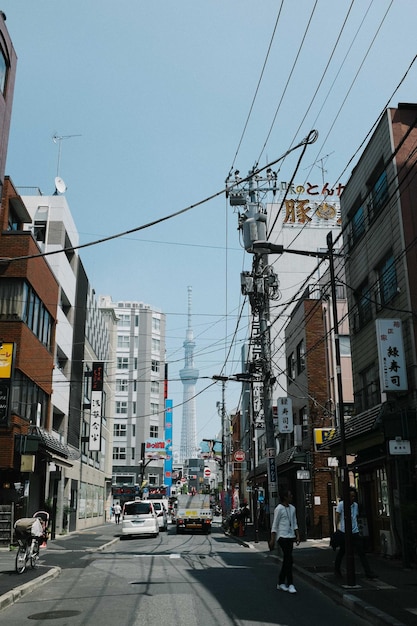 Cars on road in city against clear sky