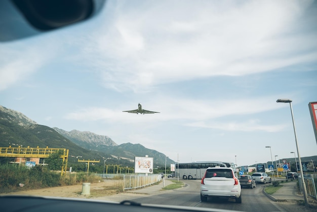 Cars on road and plane in sky travel concept