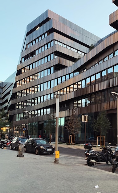 Cars on street by buildings against sky in city