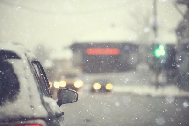 cars on winter road traffic jam city / winter weather on the city highway, the view from car in the fog and snow road