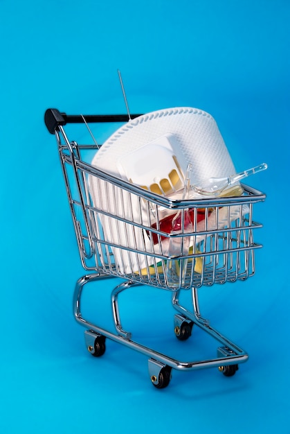 Cart from the store with a medical mask and medicines